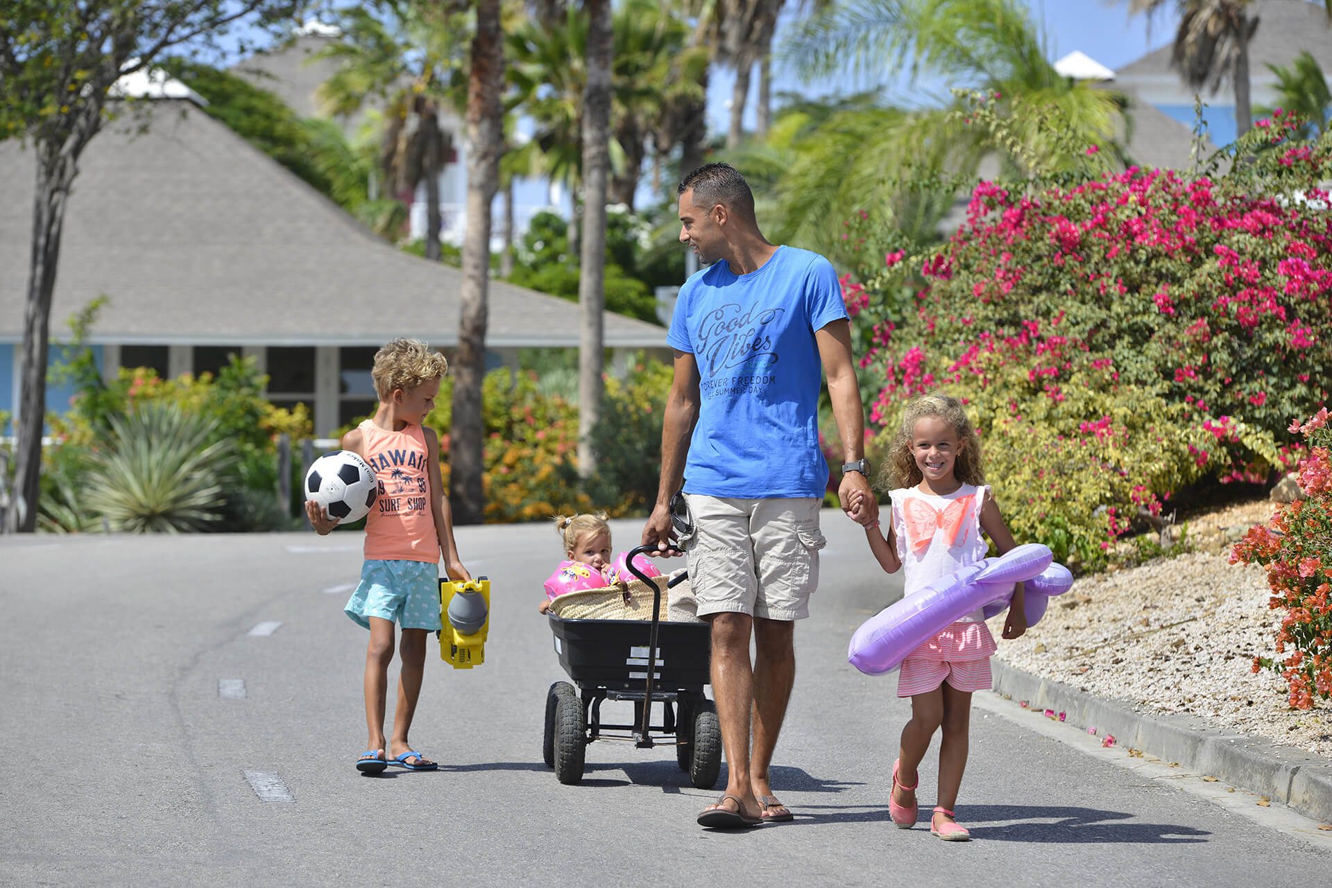 A family enjoying their rental beach cart at Chogogo Curacao.